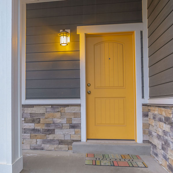 yellow front door and gray siding